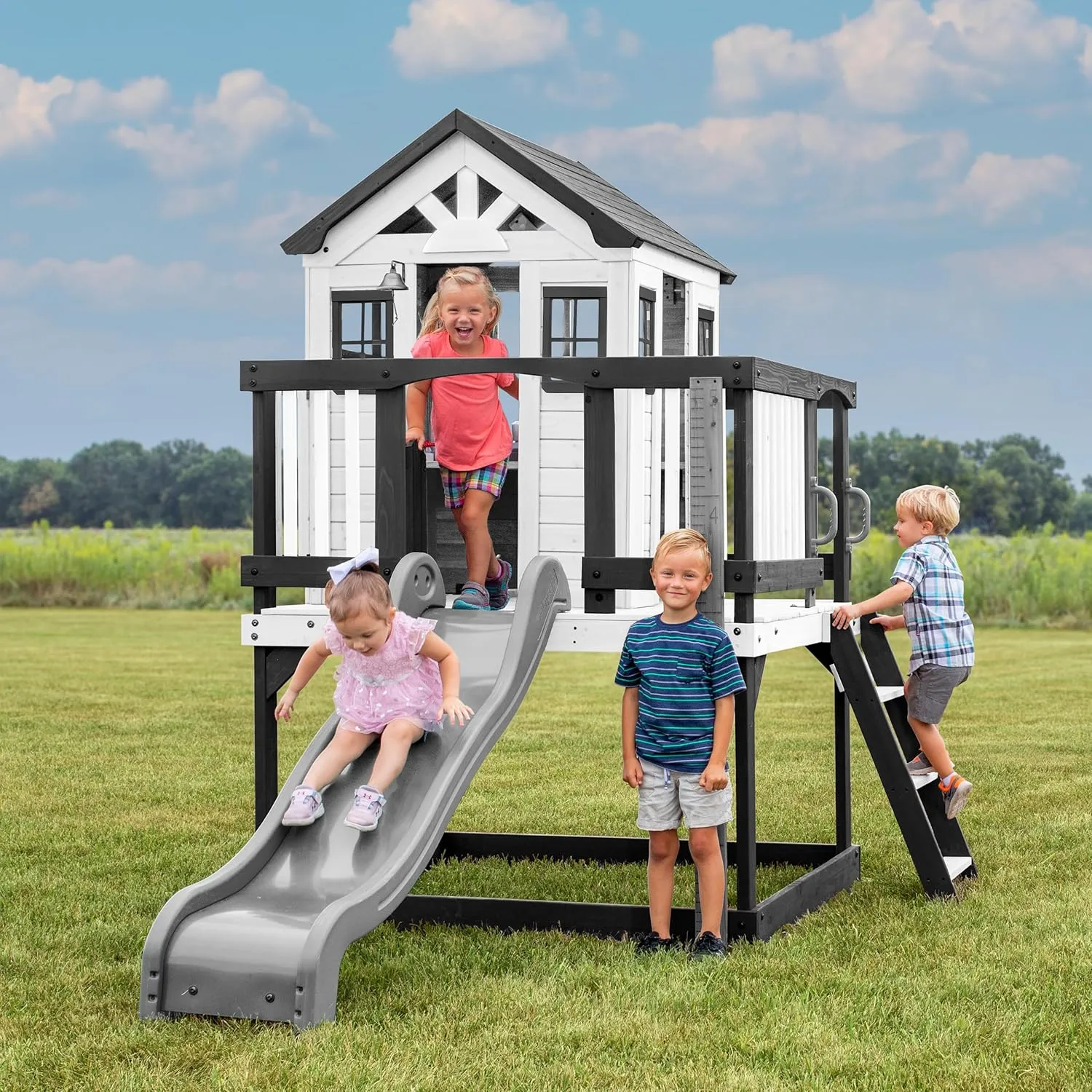 Backyard Discovery Sweetwater Heights White Elevated Cedar Wooden Kids Playhouse with Wave Slide, Play Kitchen, Step Ladder, Half Door, Wrap-Around Deck, Windows, Bell, Growth Chart for Outdoor Play
